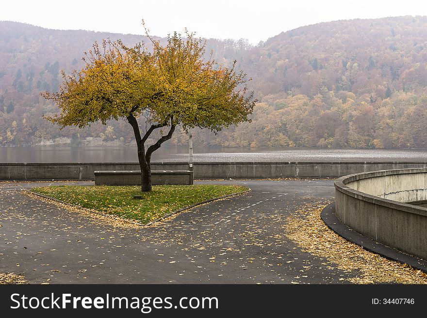 Autumn at the Lake Rożnów in Malopolska , Poland. An empty parking lot on a dam.