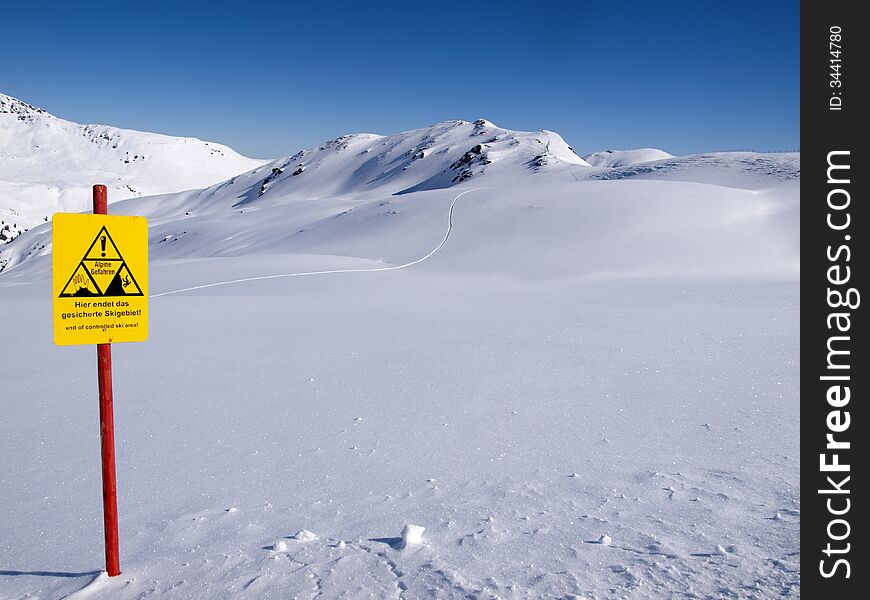 The end of the controlled ski area high in the Alps