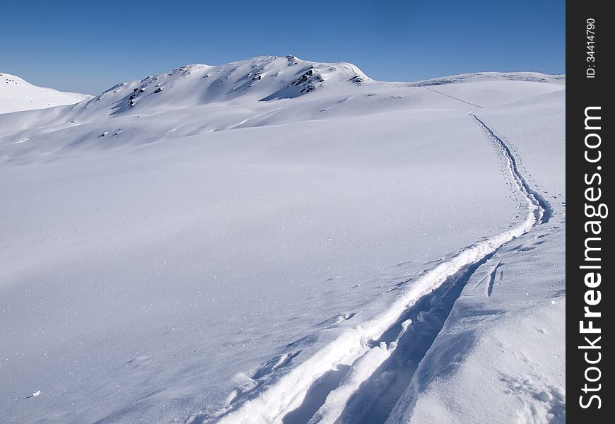 Deep skiing tracks in the snow on the alps in Austria. Deep skiing tracks in the snow on the alps in Austria