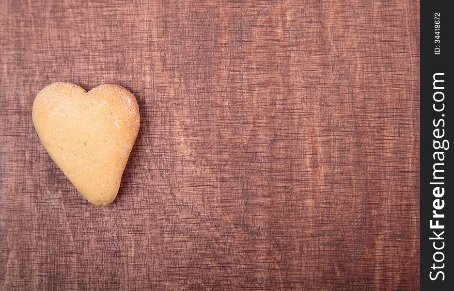 Valentine background.Cookies in the form of heart on a wooden background