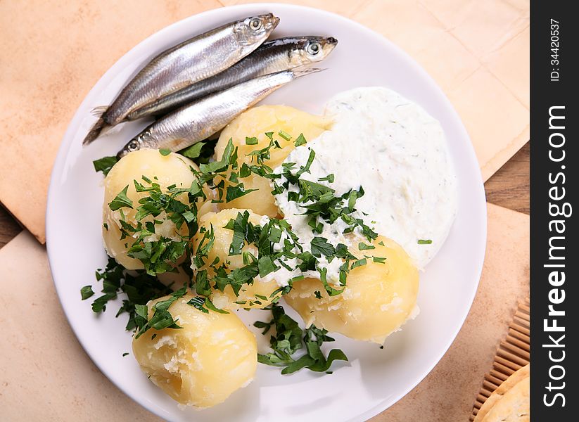 Potato and small fish with sauce