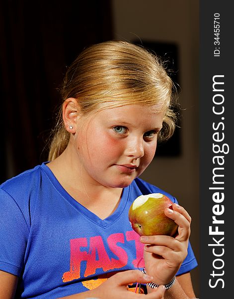 Portrait of young girl eating apple