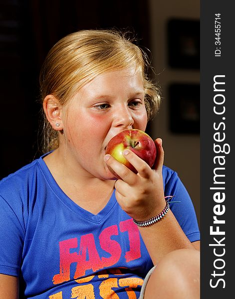 Portrait of young girl eating apple