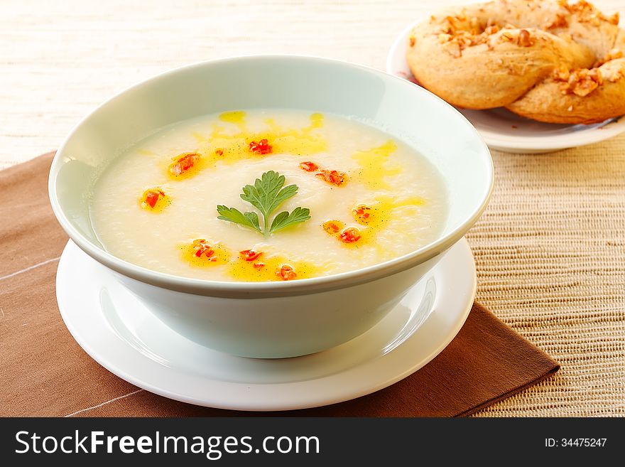 Creamy cauliflower soup with fresh parsley and red pepper