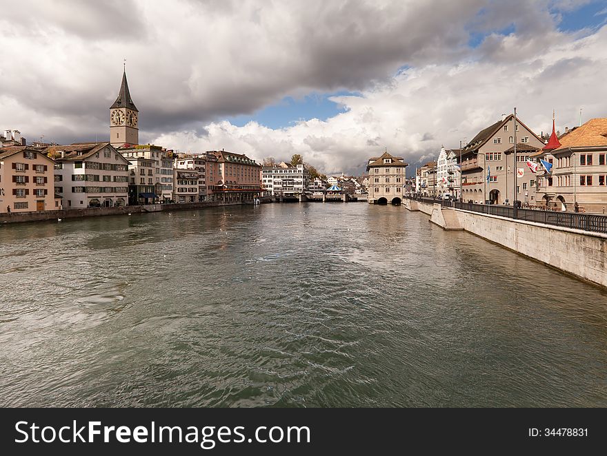 Zurich, Switzerland on a cloudy winter day. View along the Limmat river from MÃ¼nsterbrÃ¼cke towards RathausbrÃ¼cke. Zurich, Switzerland on a cloudy winter day. View along the Limmat river from MÃ¼nsterbrÃ¼cke towards RathausbrÃ¼cke.