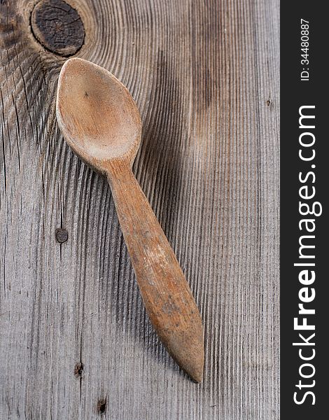 Old wooden spoon on wooden background. Old wooden spoon on wooden background