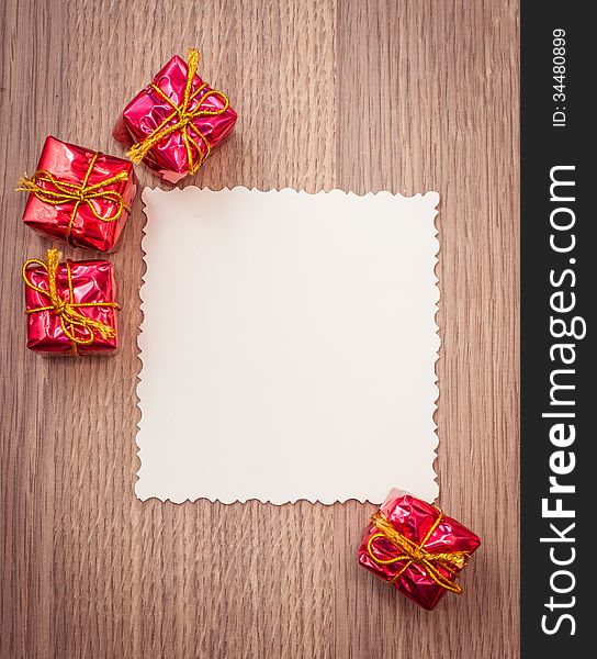 Red decorative gifts on wooden background