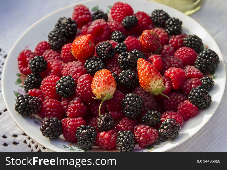 Wildberries, strawberries and raspberries in a bowl. Wildberries, strawberries and raspberries in a bowl