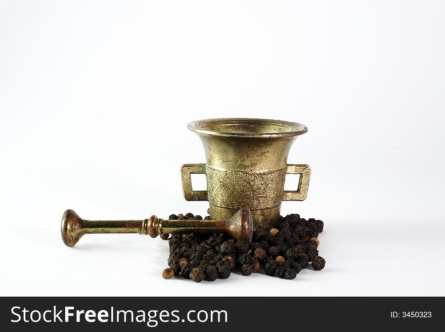 Mortar,pestle and pepperin the white background. Mortar,pestle and pepperin the white background