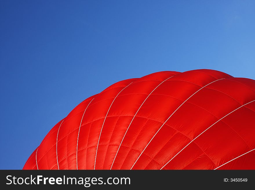 A close-up of the outside of a red air balloon. A close-up of the outside of a red air balloon