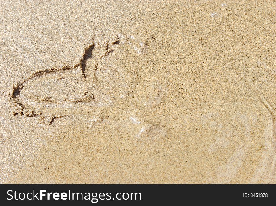 Heart drawn on golden sand. Heart drawn on golden sand