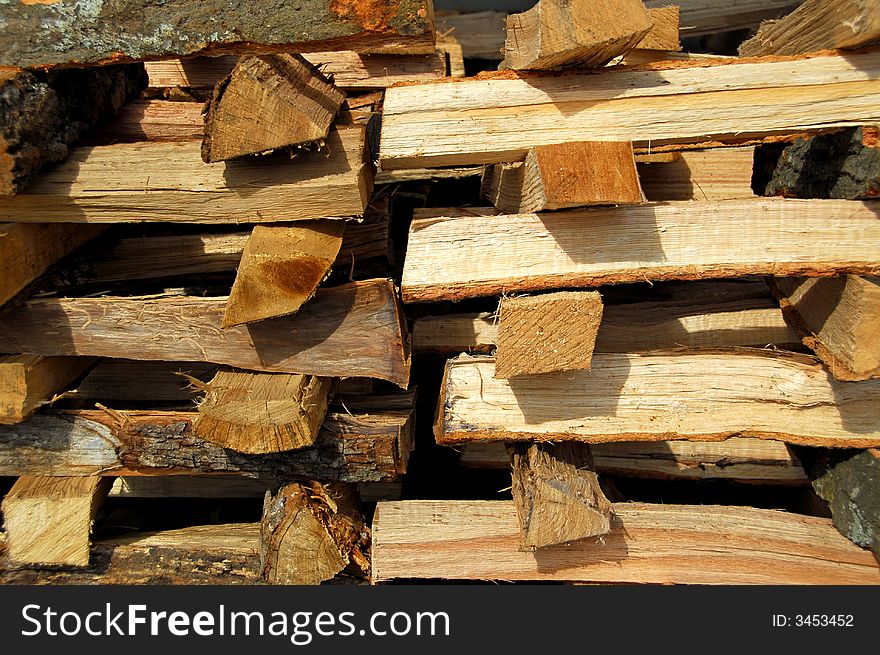 A stack of cut hardwood for fire place or stove in the winter. A stack of cut hardwood for fire place or stove in the winter