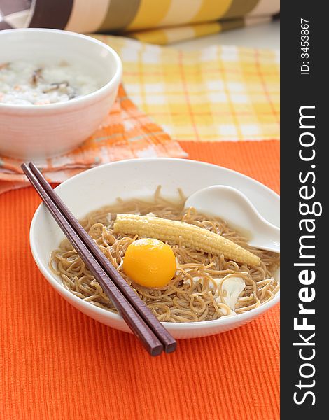 Brown Chinese buckwheat noodles with egg and baby corn in light soup