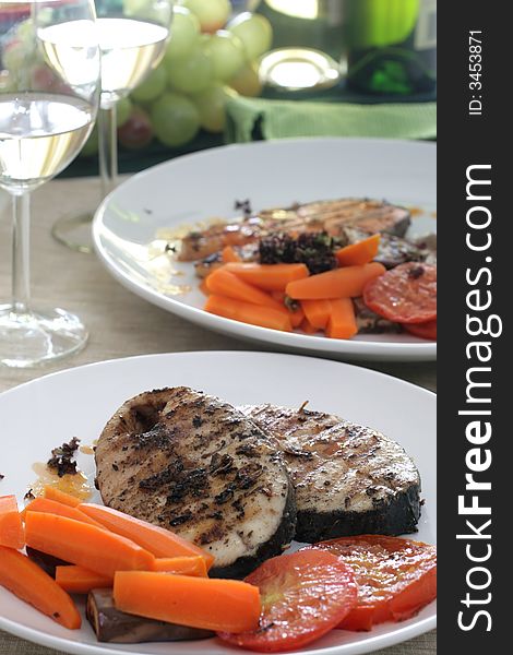 Pan seared mackerel served with carrots, sliced tomatoes and white wine