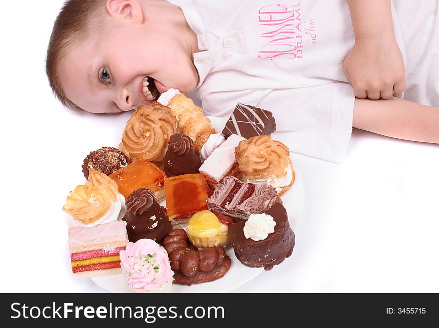 Boy is eating sweet desert on the white background. Boy is eating sweet desert on the white background