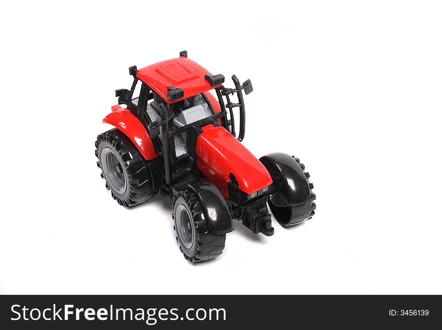 Red tractor toy on the white background