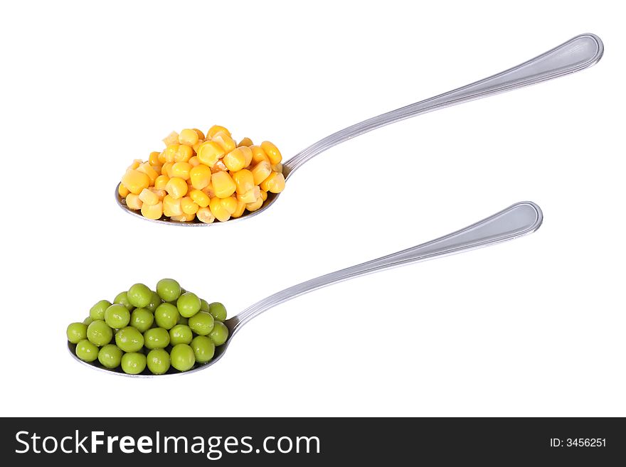 Spoonfuls with peas and corn isolated on white background. Spoonfuls with peas and corn isolated on white background