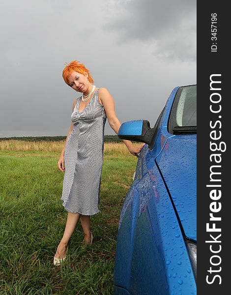 Woman In Dress With Blue Car