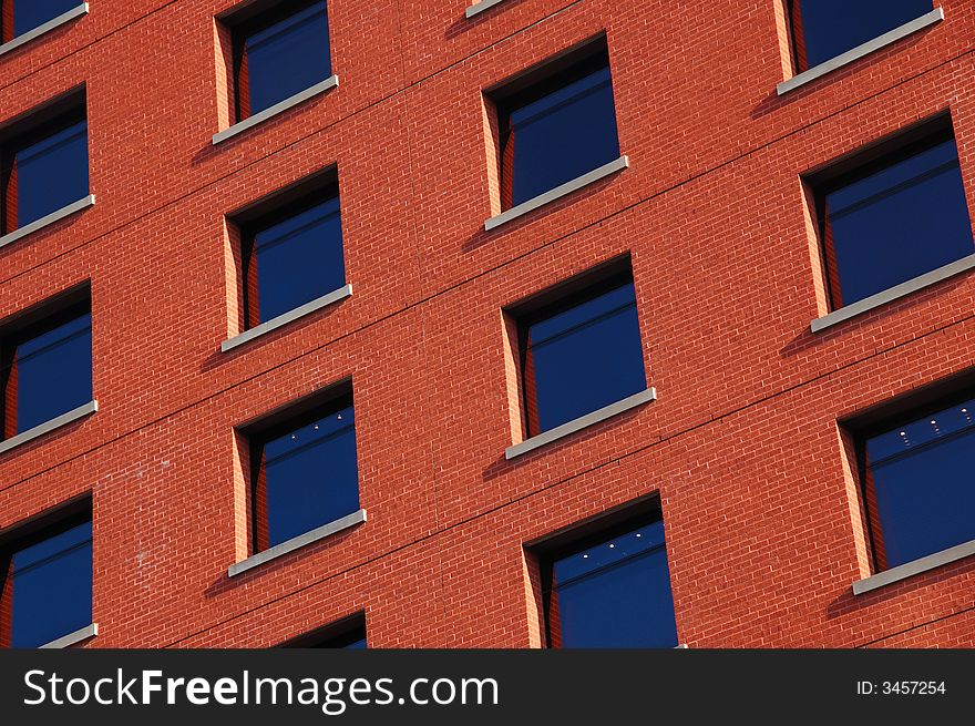 Pattern of dark blue windows on the red wall