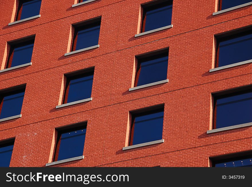 Pattern of dark blue windows on the red wall