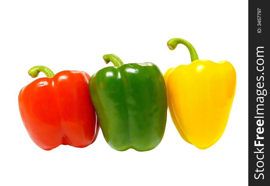 A red, green and yellow paprika queuing up isolated on a white background with shadows. A red, green and yellow paprika queuing up isolated on a white background with shadows