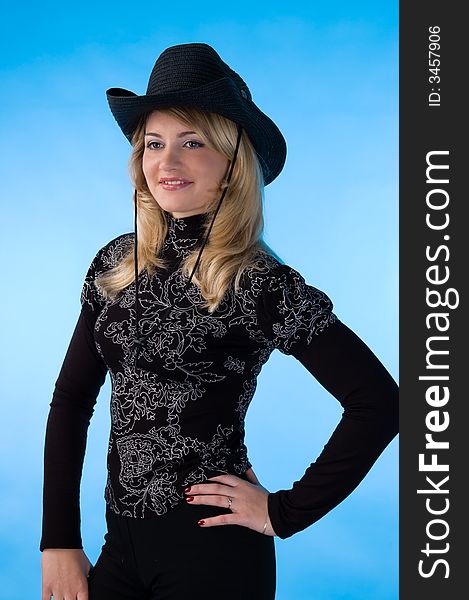 The beauty blonde in the studio, isolated on a blue background. The beauty blonde in the studio, isolated on a blue background.