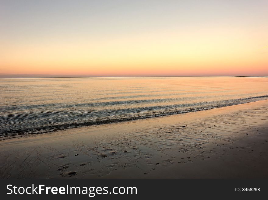 Sunset on Crane's beach in Ipswich Massachusetts with land way off in the distance. Sunset on Crane's beach in Ipswich Massachusetts with land way off in the distance