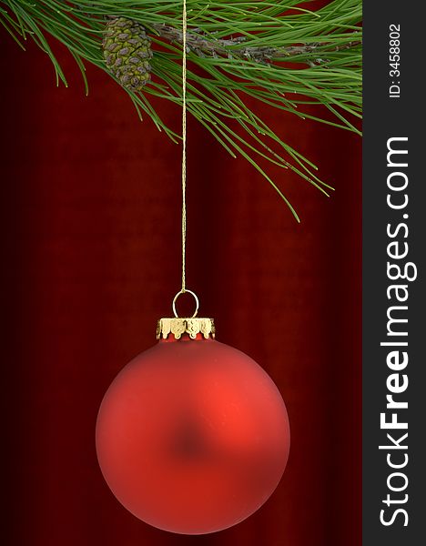 An image of a red Christmas ornament on a burgundy background