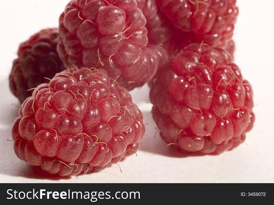 Five raspberries isolated on awhite background