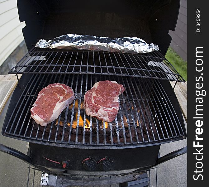 A photo of 2 steaks on a grill