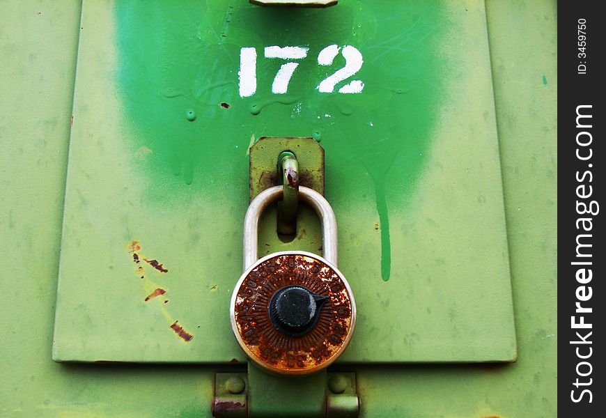 A rusty old combination lock on green mailbox. Could be used to illustrate forgotten combination. A rusty old combination lock on green mailbox. Could be used to illustrate forgotten combination.