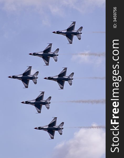 Six jets flying in formation during an air show. Six jets flying in formation during an air show.