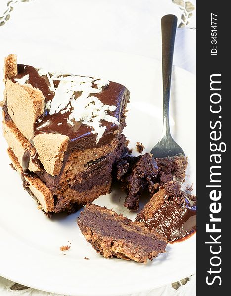Slice of chocolate cake decorated with white chocolate flakes. From the series French Desserts