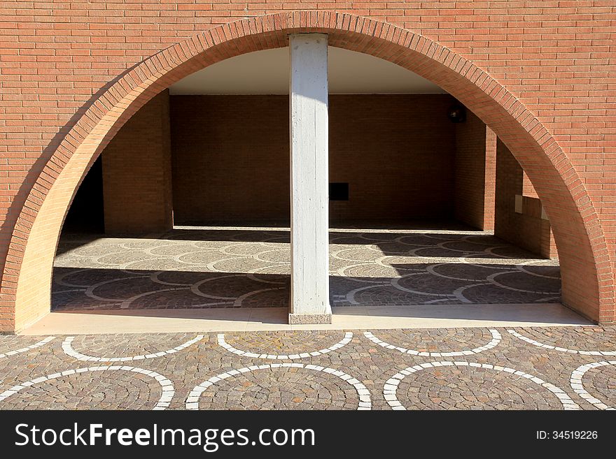 View of architectural detail of a wall of modern construction. In the picture you can see the red bricks used in some modern building in Italy