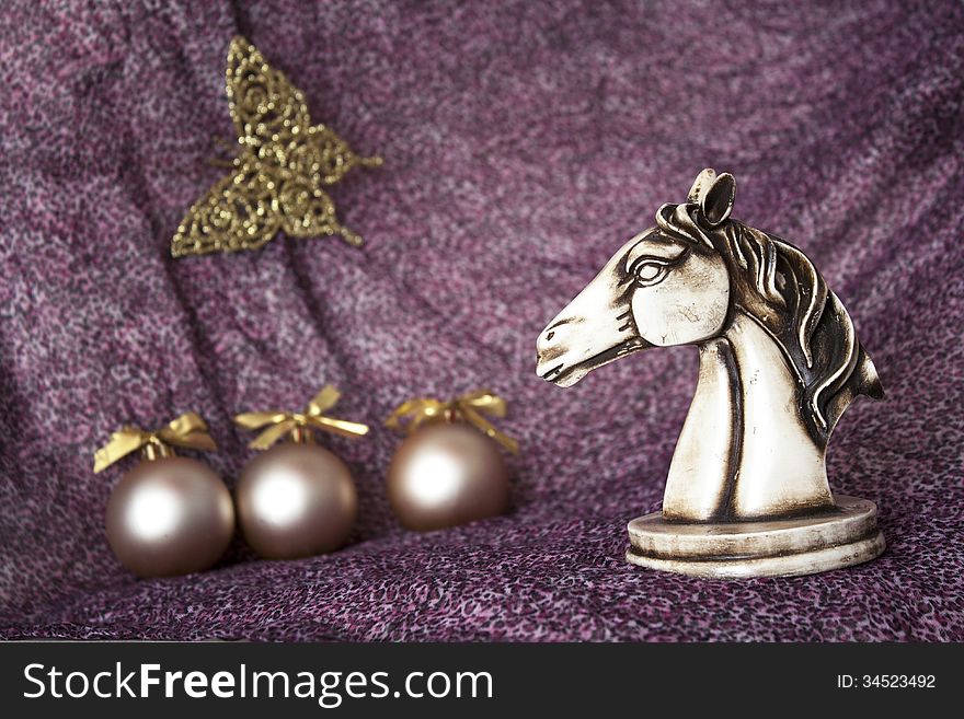 Statuette of horse on the New Year toys background. Statuette of horse on the New Year toys background