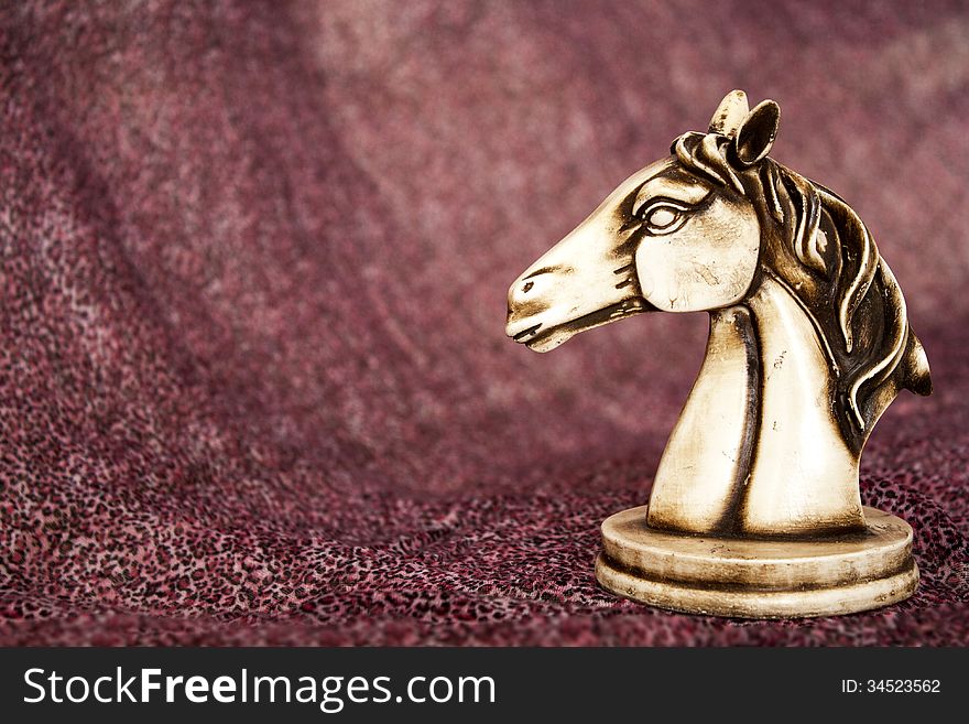 Statuette of horse on the purple background