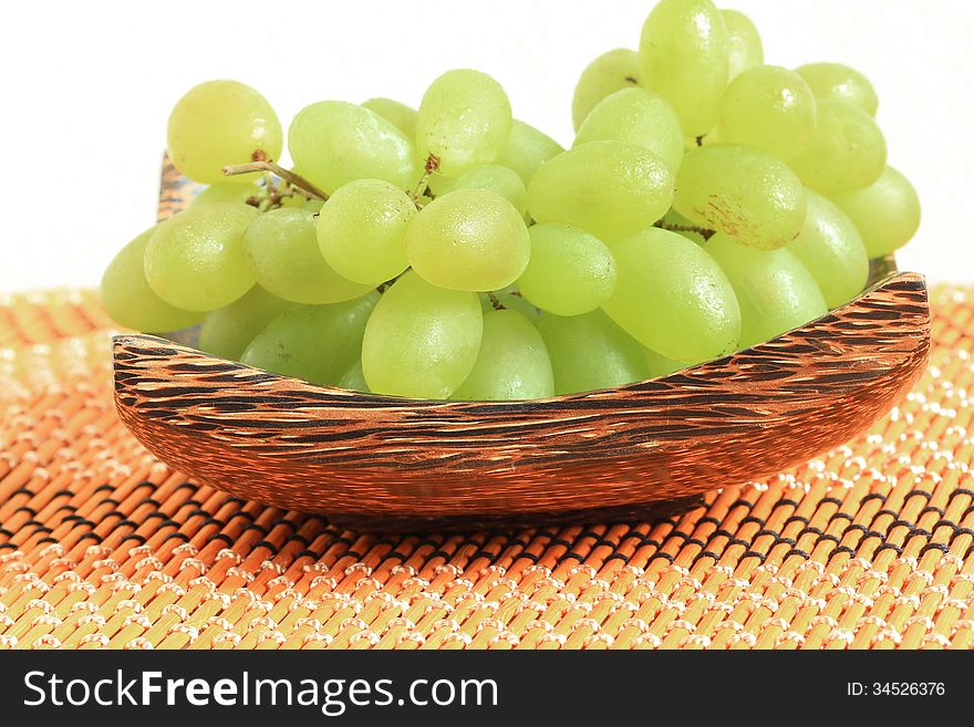 Green grapes in a wooden tray