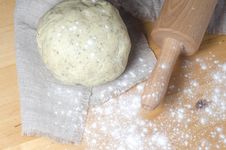 Dough, Rolling Pin And Flour On A Wooden Table. Royalty Free Stock Photography Dough, Rolling Pin And Flour On A Wooden Table. Royalty Free Stock Photography