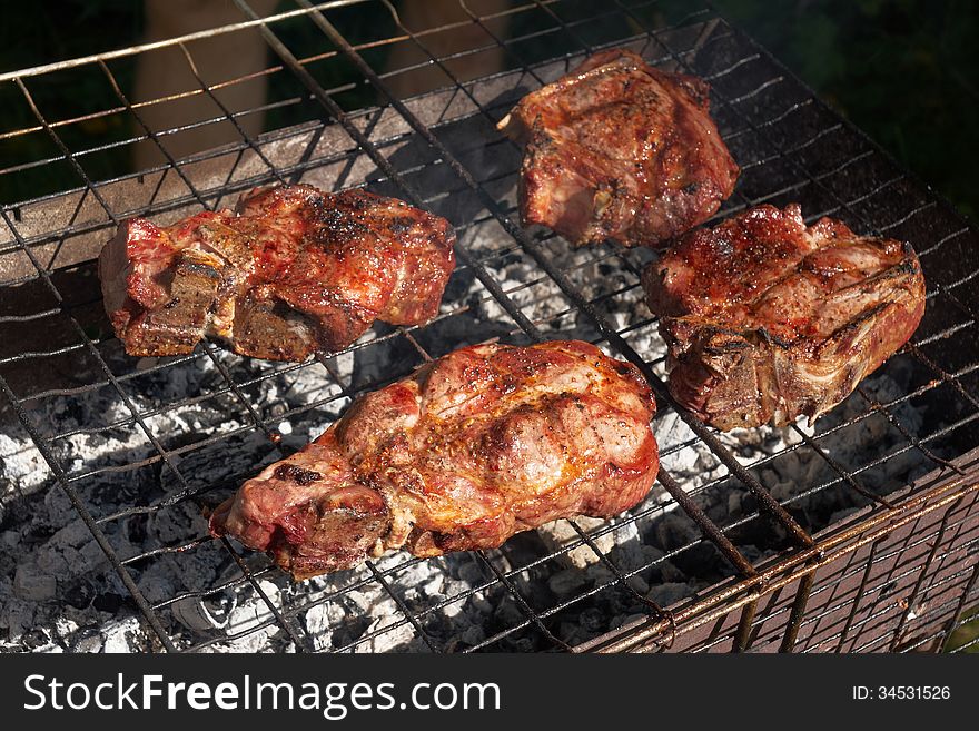 Roasted meat on grill outdoor. Roasted meat on grill outdoor