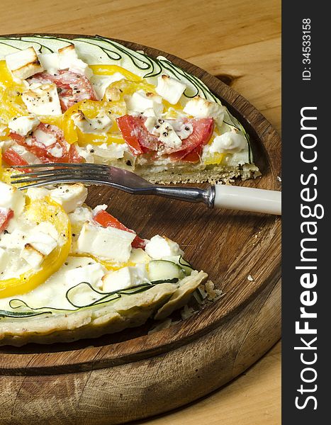 Ready vegetable pie on wooden cutting board. From series Cooking vegetable pie