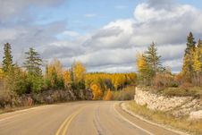 Winding Highway Between A Rock Ridge And Trees Stock Photo