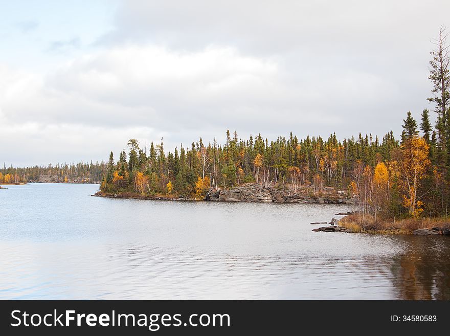 A winding lake surrounded by fall trees