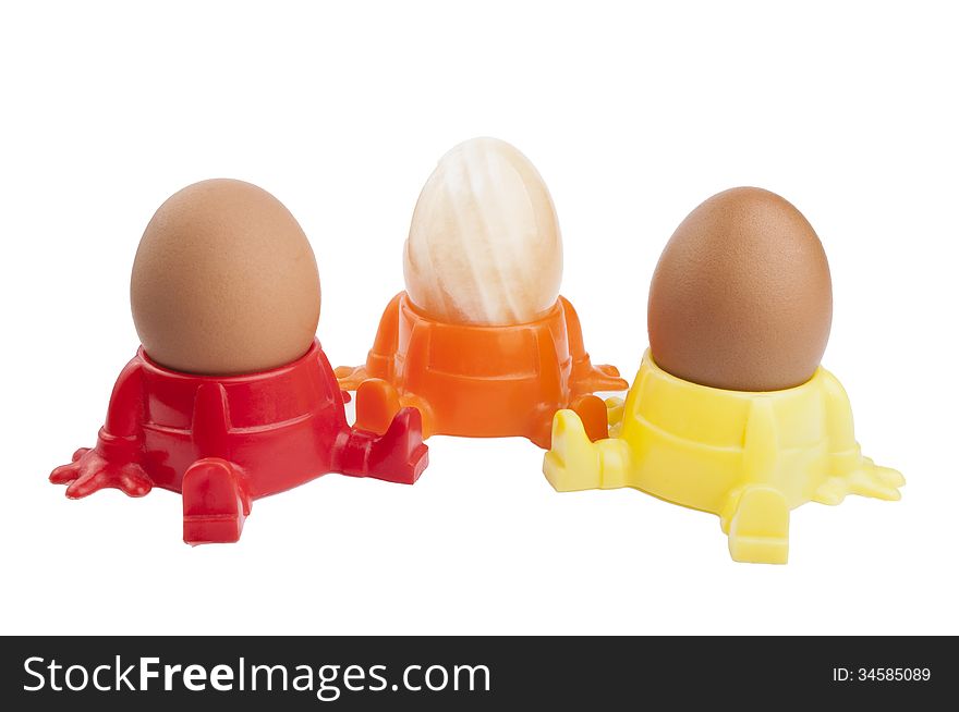 Two whole boiled egg and one onyx in egg cup isolated on white background