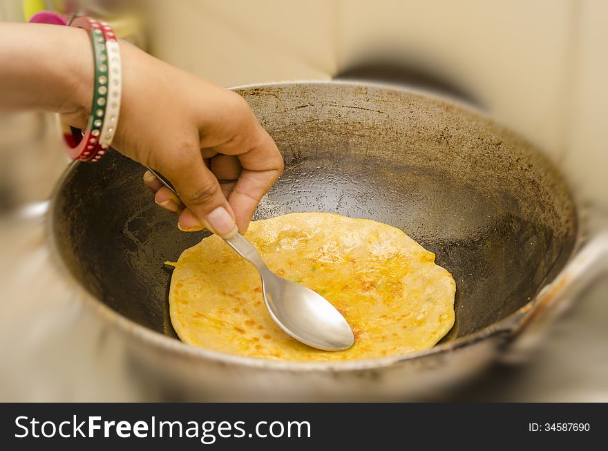 Frying karai or pan prantha indian breakfast in refined oil. Frying karai or pan prantha indian breakfast in refined oil