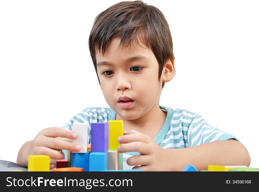 Little boy play block on white background