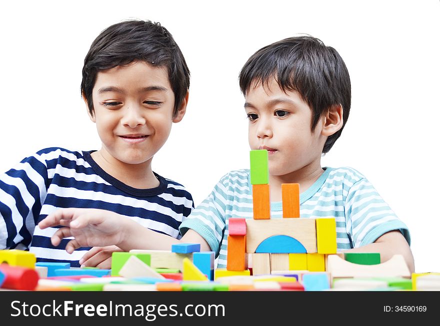 Little sibling boy play block on white background