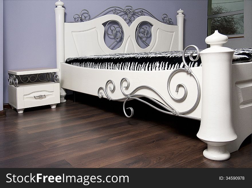 White bed in an interior in modernist style. White bed in an interior in modernist style