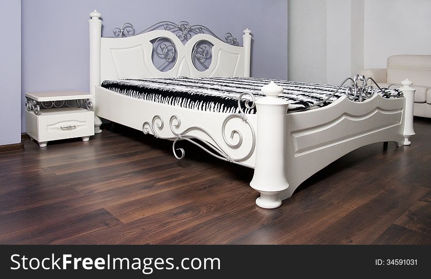 White bed in an interior in modernist style. White bed in an interior in modernist style