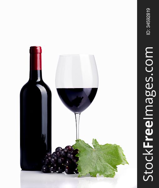 Bottle of wine with glass and grapes on white desk over white background. Bottle of wine with glass and grapes on white desk over white background.