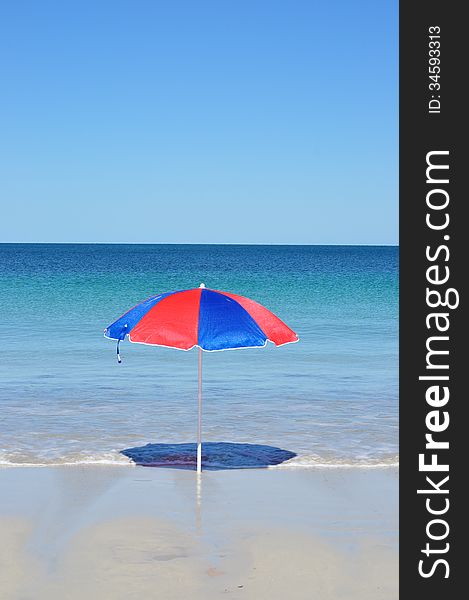 Beach umbrella set up on the beach by the sea. Beach umbrella set up on the beach by the sea